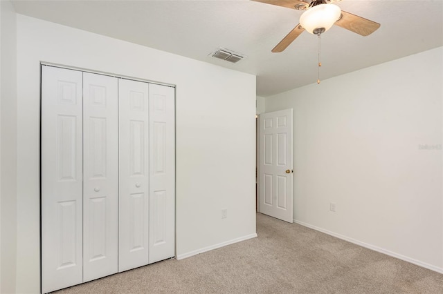 85 Levee Ln, Ormond Beach, FL 32174 - unfurnished bedroom with light carpet, a closet, and ceiling fan