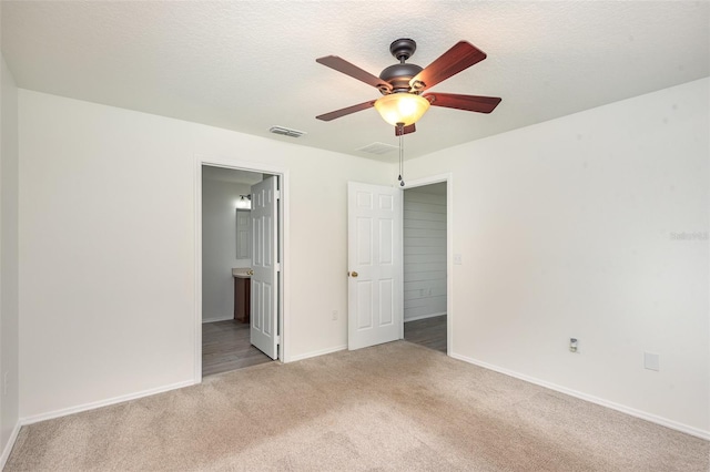 85 Levee Ln, Ormond Beach, FL 32174 - unfurnished bedroom with carpet floors, connected bathroom, and ceiling fan