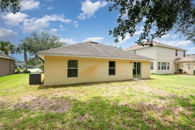 85 Levee Ln, Ormond Beach, FL 32174 - rear view of house featuring stucco siding, a yard, and roof with shingles