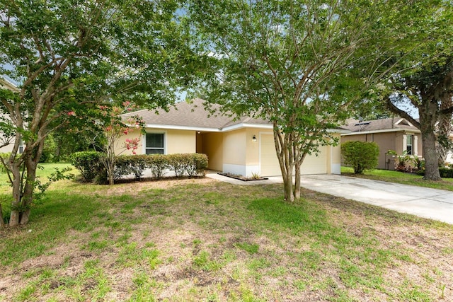 85 Levee Ln, Ormond Beach, FL 32174 - view of front of home with a garage, driveway, stucco siding, and a front yard