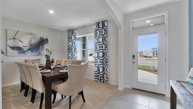 33608 Seattle Slew Dr, Sorrento, FL 32776 - dining area featuring light carpet, recessed lighting, light tile patterned floors, and arched walkways