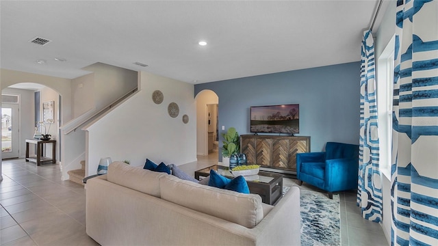 33608 Seattle Slew Dr, Sorrento, FL 32776 - living area featuring arched walkways, stairway, tile patterned floors, and recessed lighting