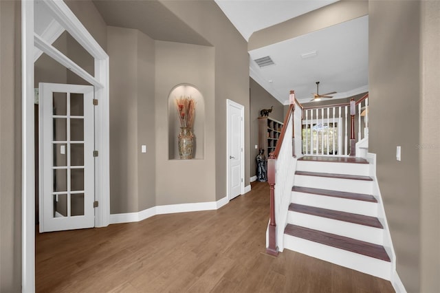 1462 Palm Bay Ct, Lake Mary, FL 32746 - stairway with ceiling fan, wood finished floors, and ornamental molding