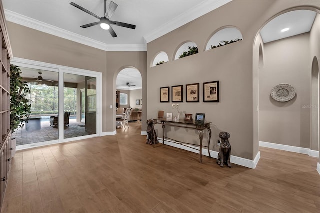 1462 Palm Bay Ct, Lake Mary, FL 32746 - entrance foyer featuring a ceiling fan, ornamental molding, wood finished floors, and arched walkways