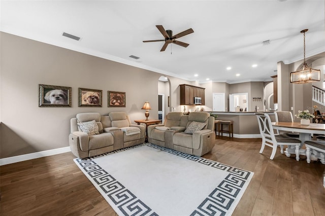 1462 Palm Bay Ct, Lake Mary, FL 32746 - living area featuring a ceiling fan, arched walkways, wood finished floors, ornamental molding, and a chandelier