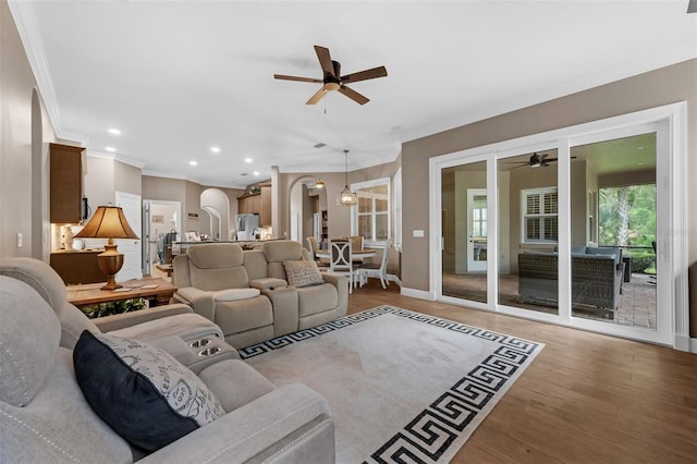 1462 Palm Bay Ct, Lake Mary, FL 32746 - living area featuring ceiling fan, ornamental molding, arched walkways, light wood-type flooring, and recessed lighting