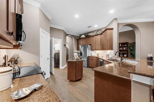 1462 Palm Bay Ct, Lake Mary, FL 32746 - kitchen with arched walkways, stainless steel appliances, ornamental molding, dark stone countertops, and light wood-type flooring