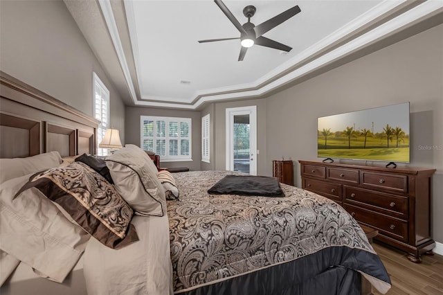 1462 Palm Bay Ct, Lake Mary, FL 32746 - bedroom with a tray ceiling, access to outside, wood finished floors, crown molding, and multiple windows