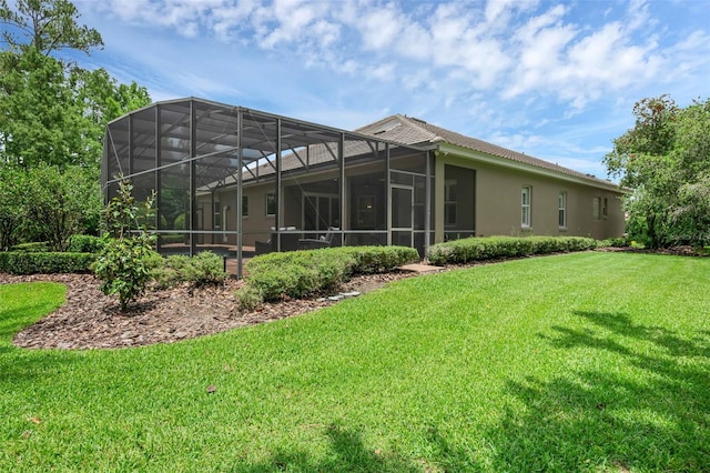 1462 Palm Bay Ct, Lake Mary, FL 32746 - rear view of property with a lawn, stucco siding, and glass enclosure