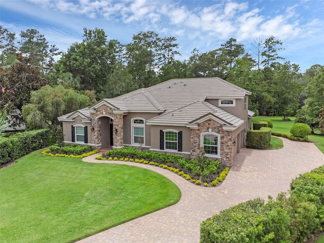 1462 Palm Bay Ct, Lake Mary, FL 32746 - view of front of home with stone siding, decorative driveway, and stucco siding