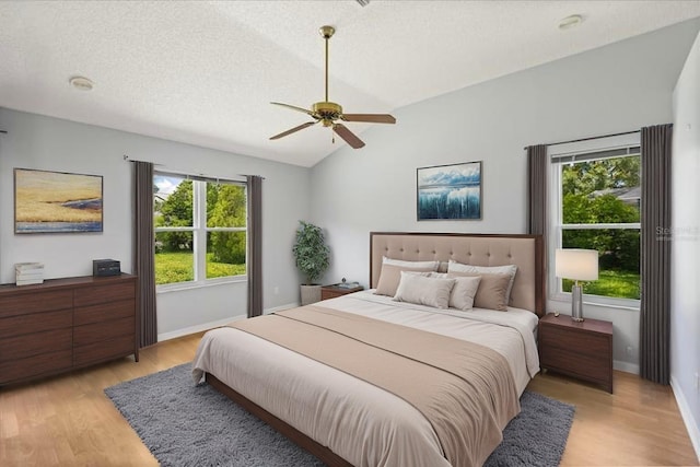 956 Chula Ct, Lady Lake, FL 32159 - bedroom featuring light wood-type flooring, vaulted ceiling, and ceiling fan
