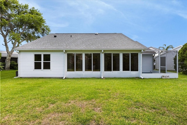 956 Chula Ct, Lady Lake, FL 32159 - rear view of house with a lawn, a shingled roof, and a sunroom