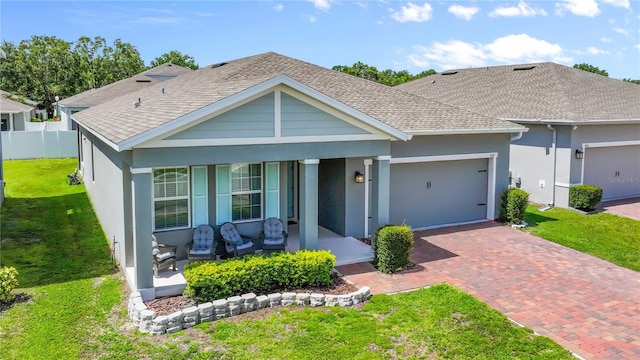 410 Winter Bliss Ln, Mount Dora, FL 32757 - view of front of house with covered porch, a shingled roof, decorative driveway, and a garage