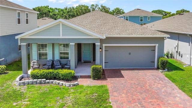 410 Winter Bliss Ln, Mount Dora, FL 32757 - view of front of property featuring covered porch, roof with shingles, a garage, a front yard, and decorative driveway