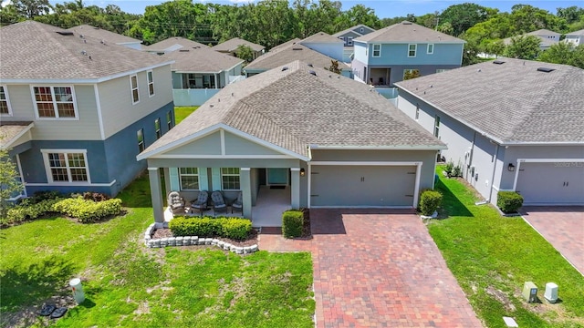 410 Winter Bliss Ln, Mount Dora, FL 32757 - view of front facade featuring decorative driveway, an attached garage, a residential view, a front yard, and stucco siding
