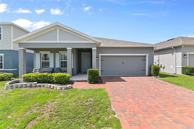 410 Winter Bliss Ln, Mount Dora, FL 32757 - view of front facade with decorative driveway, a garage, covered porch, a front yard, and stucco siding