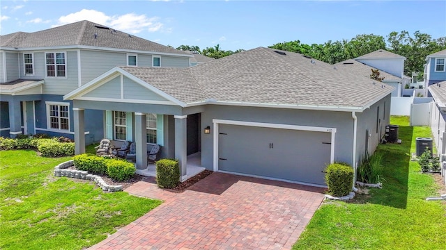 410 Winter Bliss Ln, Mount Dora, FL 32757 - view of front of property with a garage, decorative driveway, stucco siding, covered porch, and roof with shingles