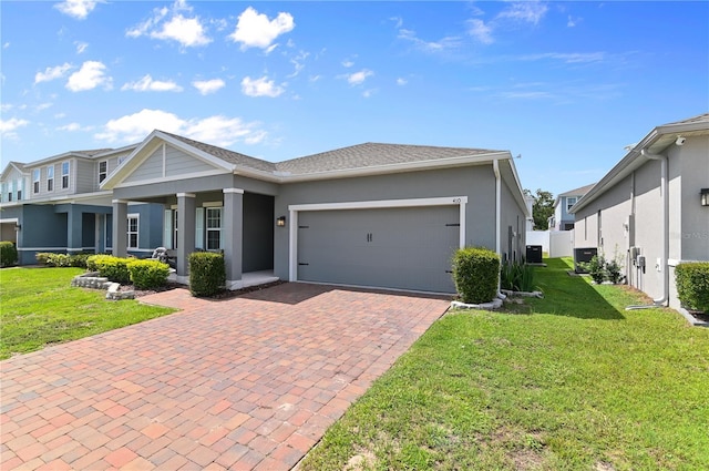 410 Winter Bliss Ln, Mount Dora, FL 32757 - view of front of property with decorative driveway, a front lawn, an attached garage, and stucco siding
