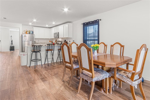 13 Ryken Ln, Palm Coast, FL 32164 - dining area featuring light wood-style flooring, recessed lighting, and a textured ceiling