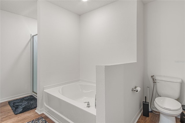 13 Ryken Ln, Palm Coast, FL 32164 - bathroom with wood finished floors, a bath, and a stall shower