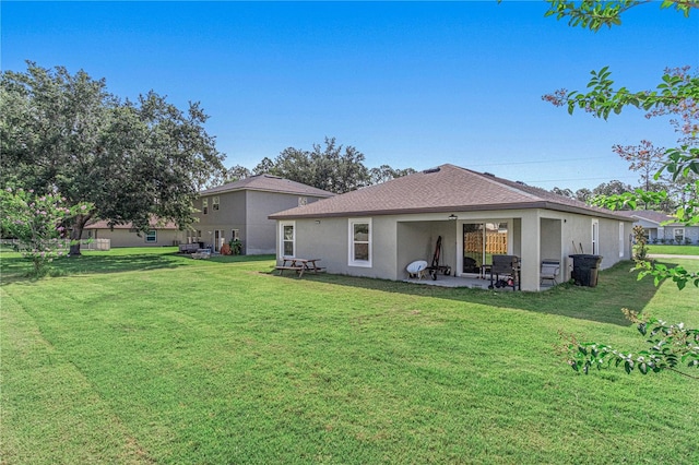 13 Ryken Ln, Palm Coast, FL 32164 - rear view of property with a yard, stucco siding, a patio, and a shingled roof