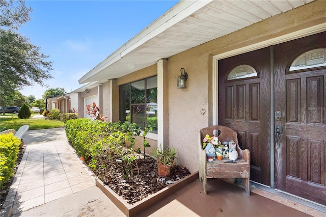 7022 Talbot Dr, Orlando, FL 32819 - doorway to property featuring stucco siding and a porch