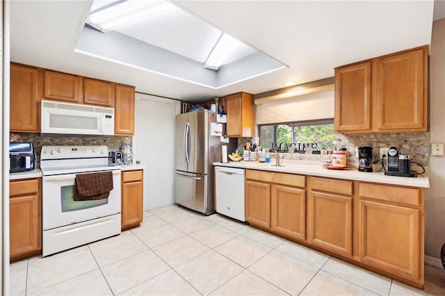 7022 Talbot Dr, Orlando, FL 32819 - kitchen featuring white appliances, decorative backsplash, light countertops, and a raised ceiling
