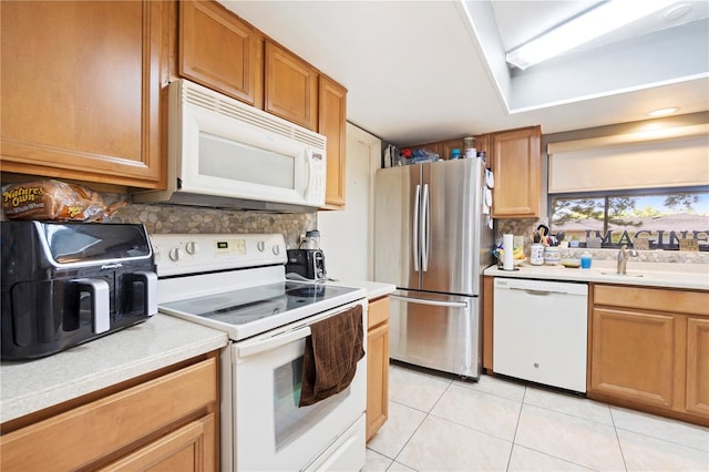 7022 Talbot Dr, Orlando, FL 32819 - kitchen featuring white appliances, light tile patterned floors, light countertops, decorative backsplash, and brown cabinets