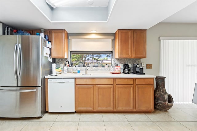 7022 Talbot Dr, Orlando, FL 32819 - kitchen with freestanding refrigerator, dishwasher, decorative backsplash, and light countertops