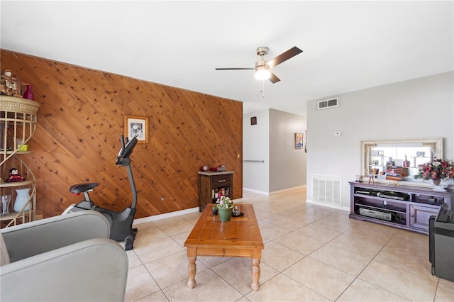 7022 Talbot Dr, Orlando, FL 32819 - living room featuring ceiling fan, an accent wall, light tile patterned floors, and wooden walls