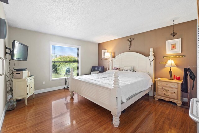 7022 Talbot Dr, Orlando, FL 32819 - bedroom featuring a textured ceiling and wood finished floors