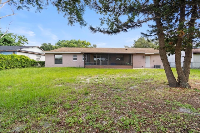 7022 Talbot Dr, Orlando, FL 32819 - back of property featuring a sunroom, stucco siding, and a yard