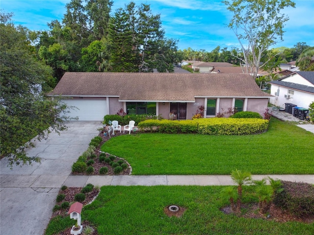 7022 Talbot Dr, Orlando, FL 32819 - ranch-style home featuring driveway, stucco siding, a front yard, a garage, and roof with shingles