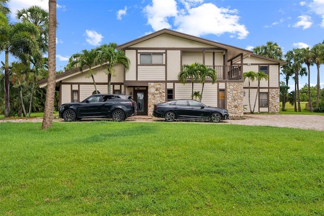 2005 SW Driftwood St, Port St Lucie, FL 34953 - view of front facade featuring stone siding and a front yard