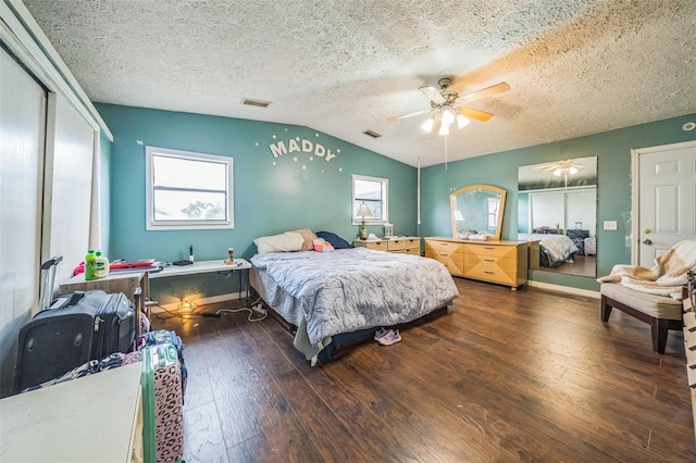 2005 SW Driftwood St, Port St Lucie, FL 34953 - bedroom featuring a textured ceiling, hardwood / wood-style flooring, vaulted ceiling, a ceiling fan, and a closet