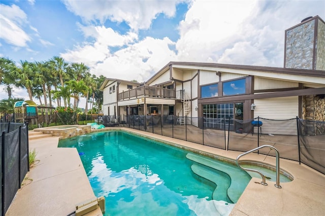 2005 SW Driftwood St, Port St Lucie, FL 34953 - view of swimming pool featuring a pool with connected hot tub and a patio area