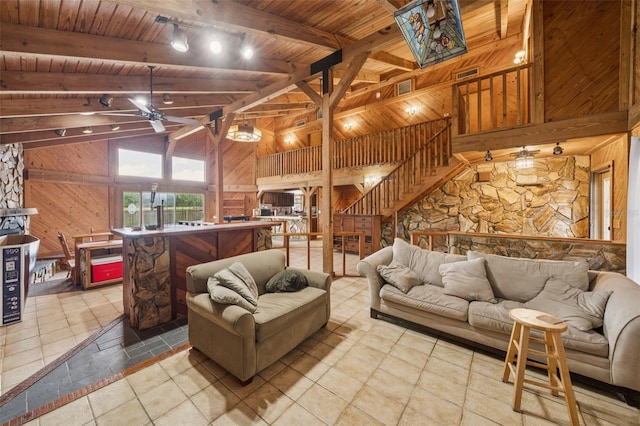 2005 SW Driftwood St, Port St Lucie, FL 34953 - living room with wood walls, a wooden ceiling with exposed beams, ceiling fan, stairs, and tile patterned floors