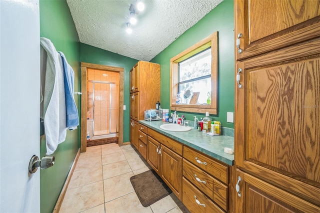 2005 SW Driftwood St, Port St Lucie, FL 34953 - bathroom with a shower stall, tile patterned flooring, a textured ceiling, and vanity