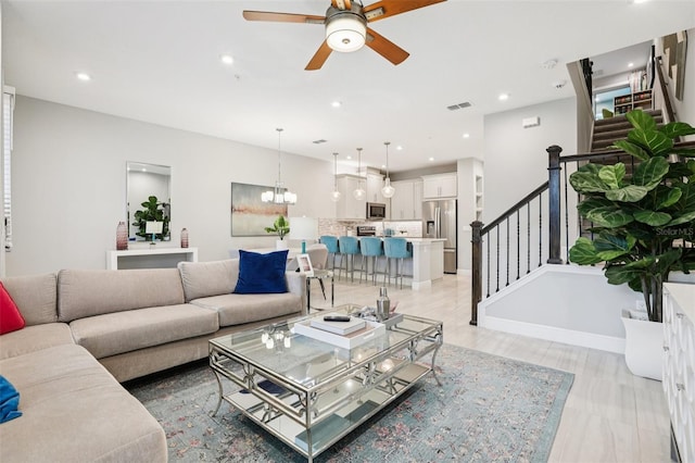 10009 Randal Walk St, Orlando, FL 32832 - living area with stairway, ceiling fan, recessed lighting, and a chandelier