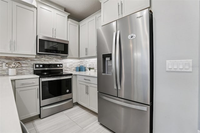 10009 Randal Walk St, Orlando, FL 32832 - kitchen featuring appliances with stainless steel finishes, light countertops, tasteful backsplash, and light tile patterned flooring