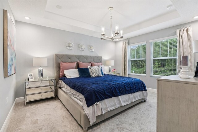 10009 Randal Walk St, Orlando, FL 32832 - bedroom with light carpet, a tray ceiling, a chandelier, and recessed lighting