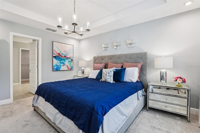 10009 Randal Walk St, Orlando, FL 32832 - bedroom featuring carpet floors, a chandelier, a tray ceiling, recessed lighting, and a spacious closet