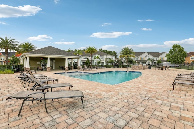 10009 Randal Walk St, Orlando, FL 32832 - community pool featuring a patio and a residential view