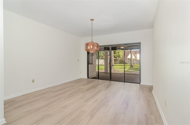 1424 Mt Laurel Dr, Winter Springs, FL 32708 - unfurnished dining area with light wood-style floors, a chandelier, and a textured ceiling