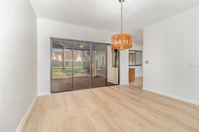 1424 Mt Laurel Dr, Winter Springs, FL 32708 - empty room featuring a chandelier, wood finished floors, and a textured ceiling