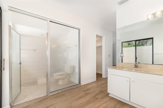 1424 Mt Laurel Dr, Winter Springs, FL 32708 - bathroom featuring a shower stall, wood finished floors, vanity, and a walk in closet