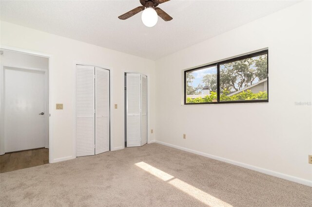 1424 Mt Laurel Dr, Winter Springs, FL 32708 - unfurnished bedroom featuring multiple closets, carpet floors, and ceiling fan