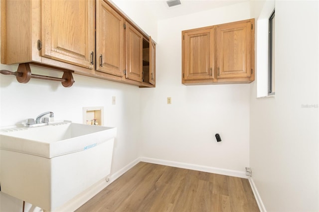 1424 Mt Laurel Dr, Winter Springs, FL 32708 - washroom featuring light wood-style flooring, hookup for a washing machine, and cabinet space