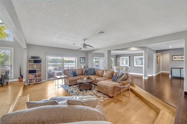 7801 Georgeann St, Winter Park, FL 32792 - living room with a textured ceiling, ceiling fan, plenty of natural light, and wood finished floors
