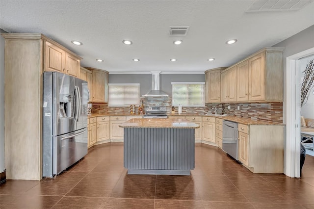 7801 Georgeann St, Winter Park, FL 32792 - kitchen with appliances with stainless steel finishes, wall chimney exhaust hood, light brown cabinets, tasteful backsplash, and ornamental molding